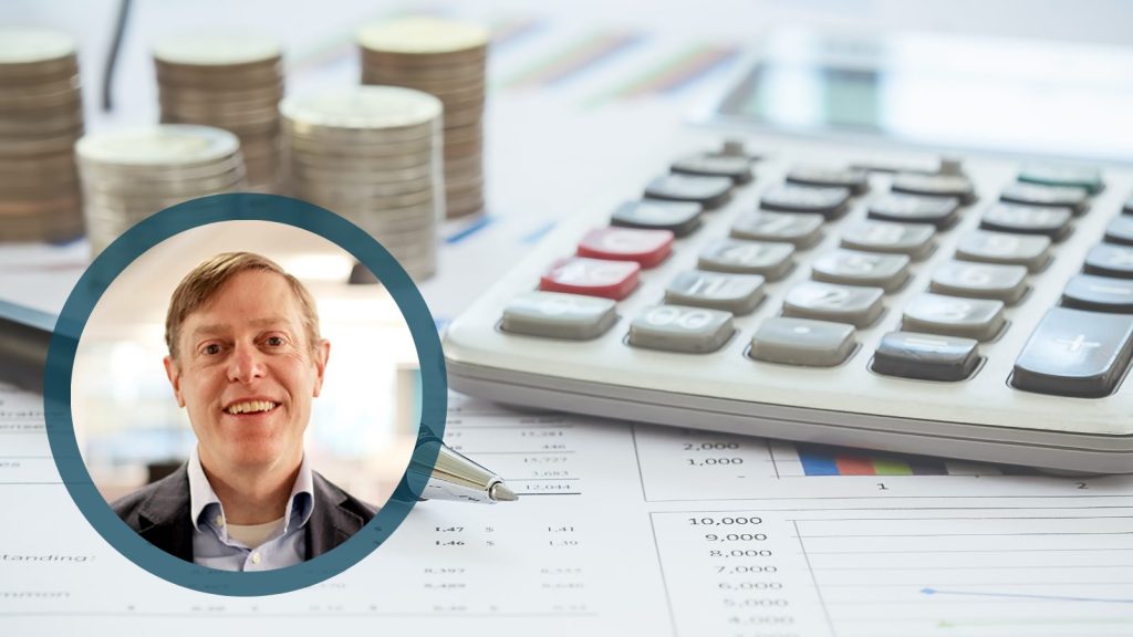 Tim Leshan with calculator and paperwork in background