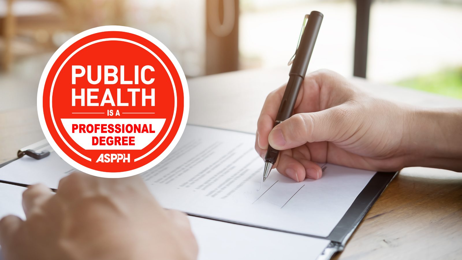 Image of Hand signing a paper with ASPPH Public Health is a Professional degree logo